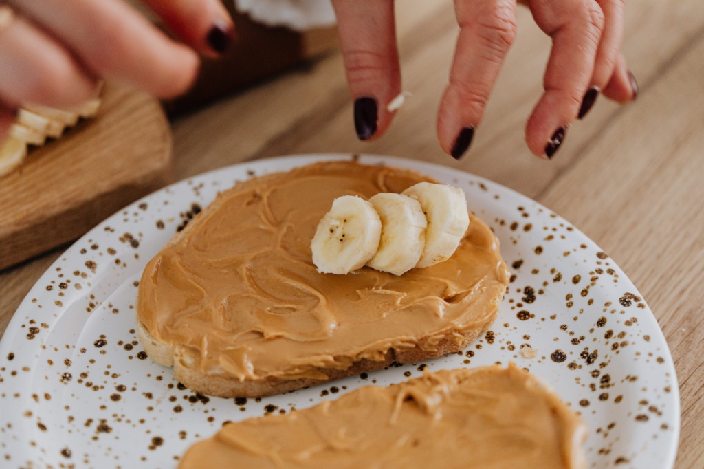 Two slices of peanut butter and banana toast on a plate.