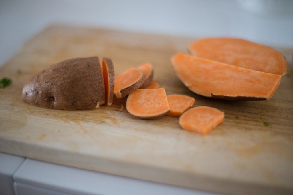 A sweet potato sliced on a cutting board